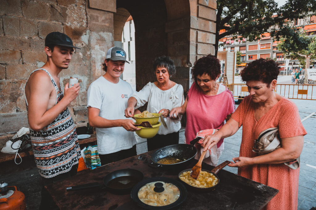 Residents and students cooking together on the square