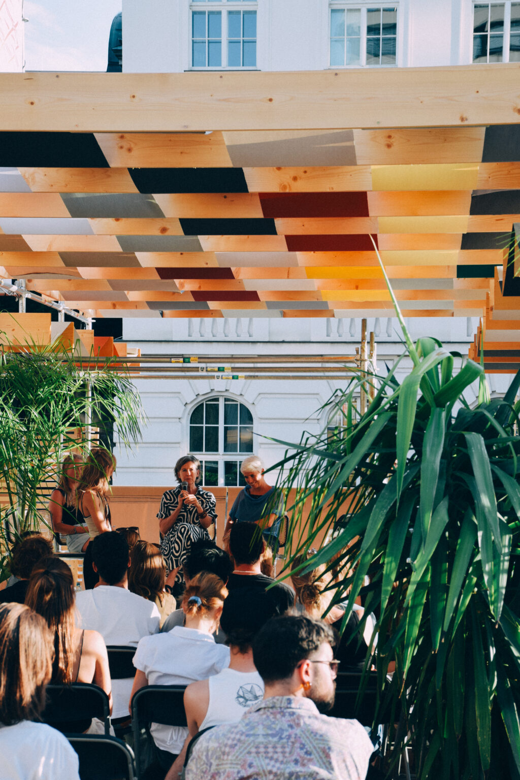 A stage talk among palms